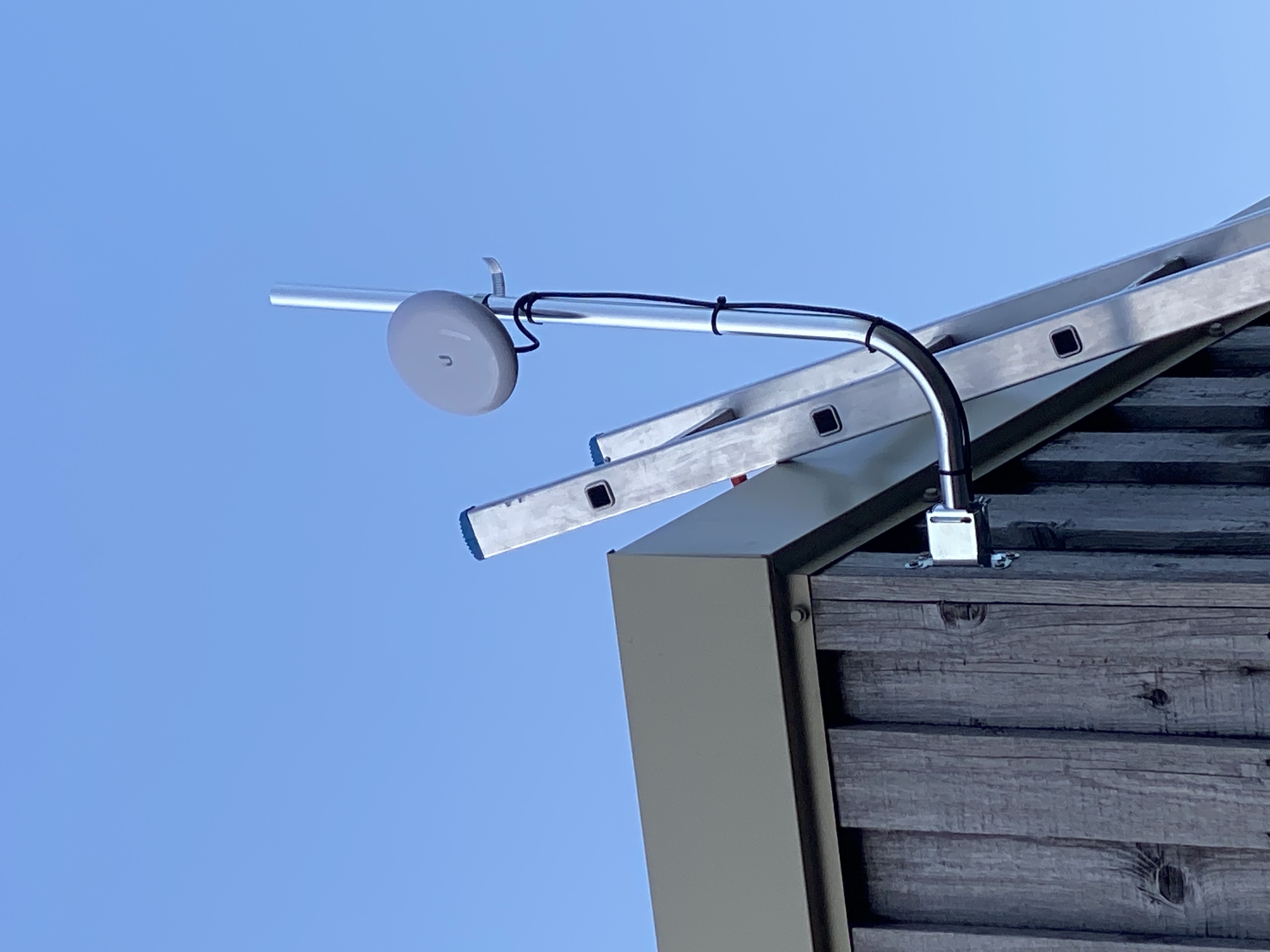 Outdoor wireless network equipment mounted above a commercial building